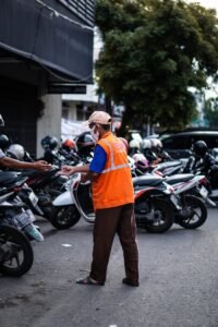 Man in Reflective Vest Standing near Motorcycles